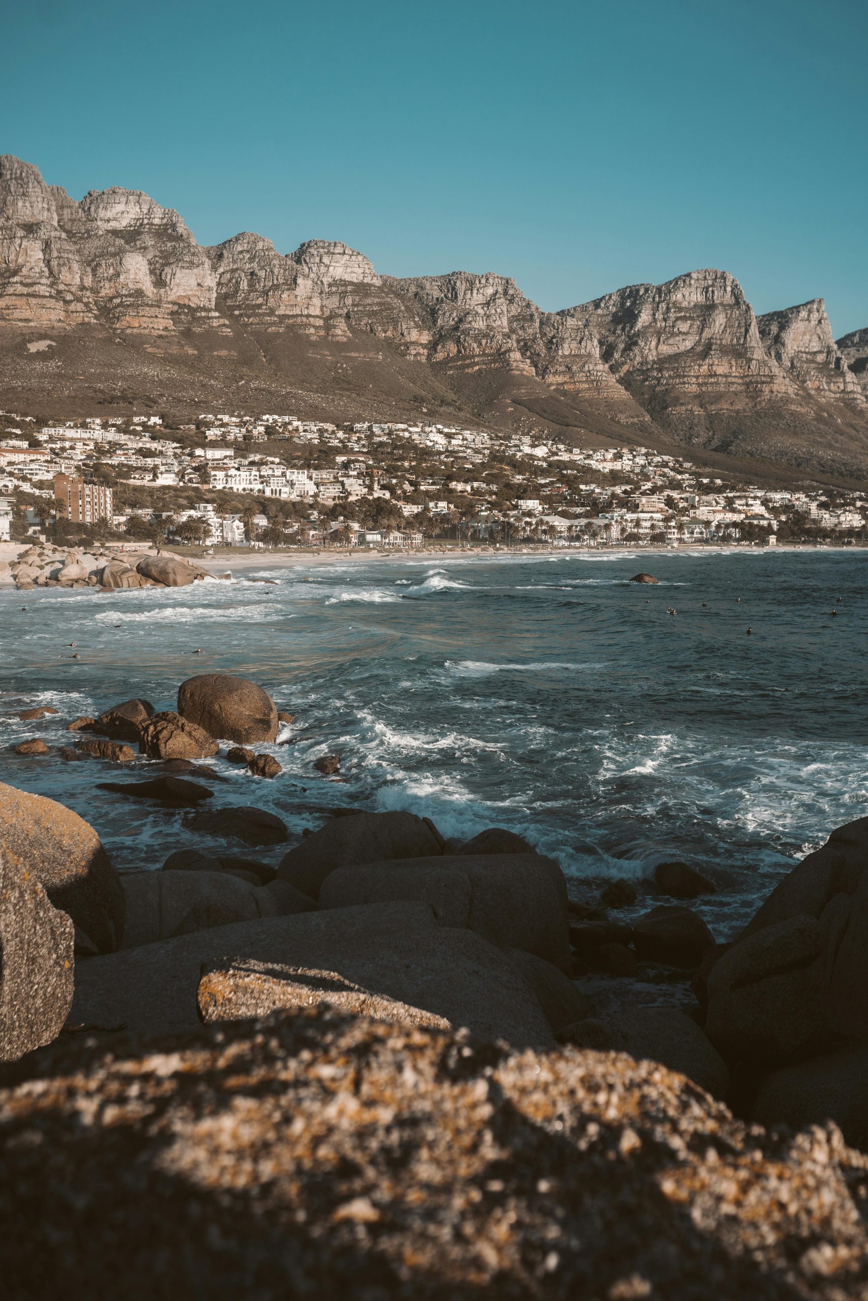 Breathtaking view of Cape Town's coastline with ocean waves and majestic rocky mountains.