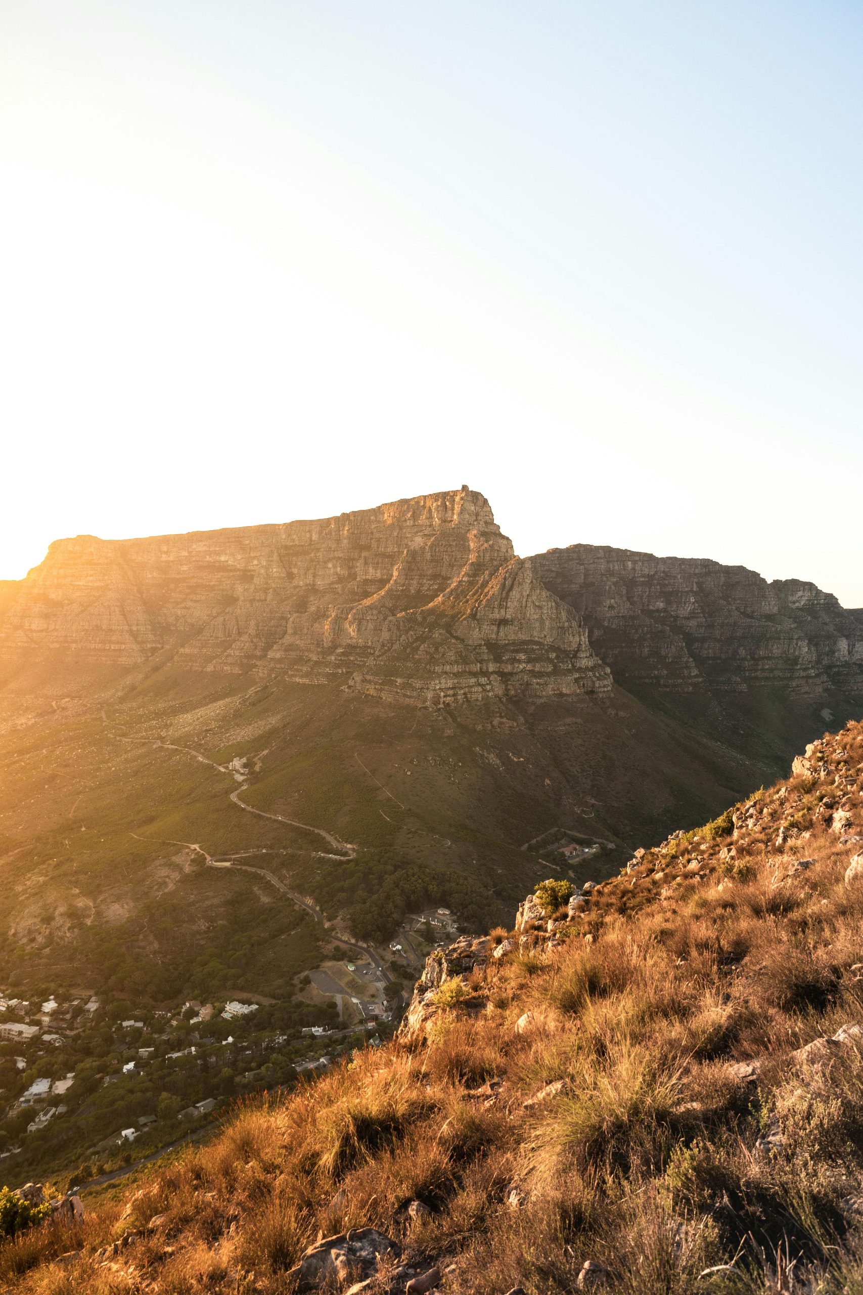 Golden light casts a warm glow over the iconic Table Mountain in Cape Town, South Africa.